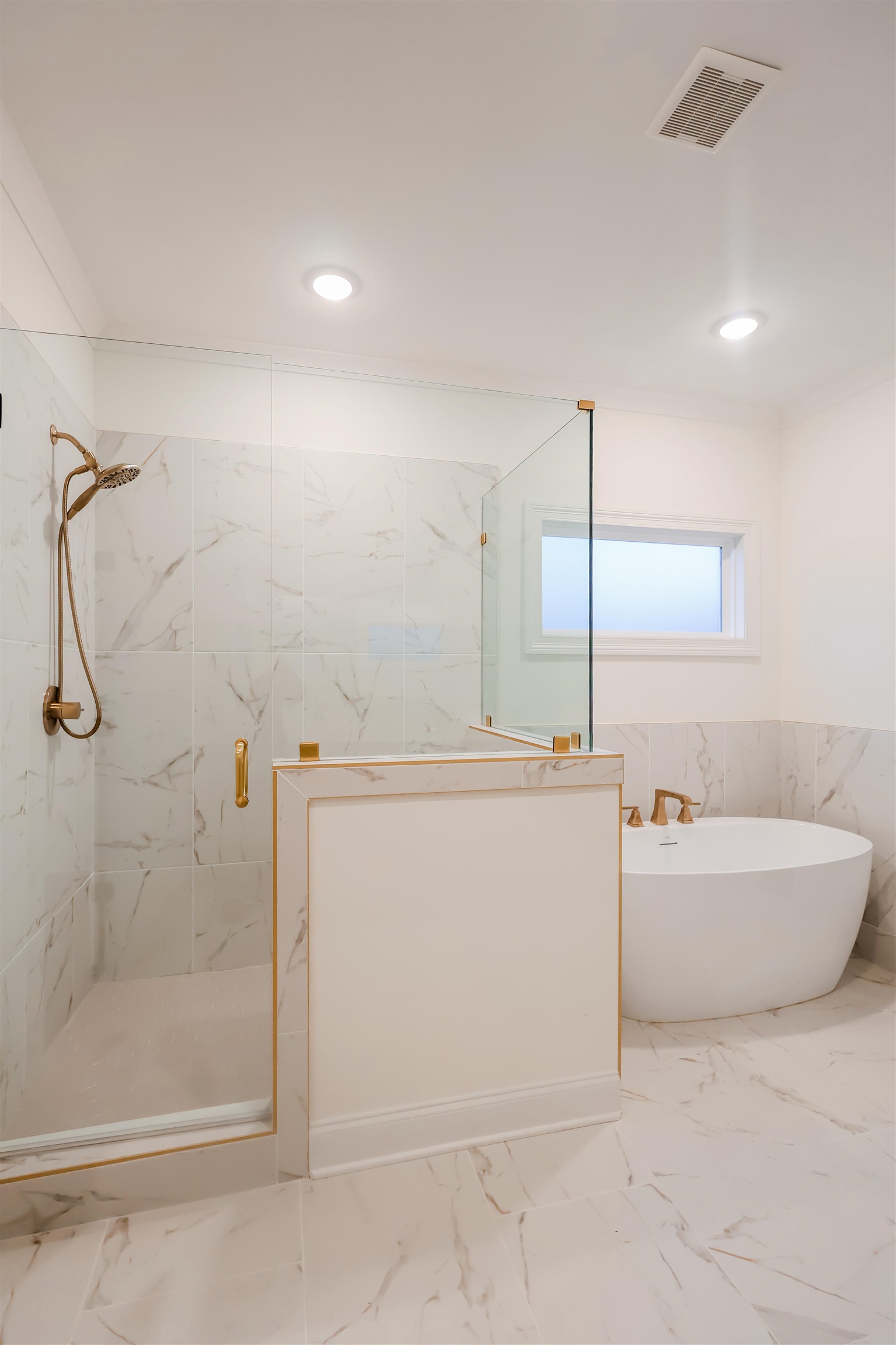 125 Columbia Way Atoka, TN 38004 - Photo 18 of 27 Bathroom with wainscoting, a marble finish shower, tile walls, a freestanding tub, and marble tiled flooring