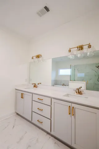 a utility room with cabinets washer and dryer