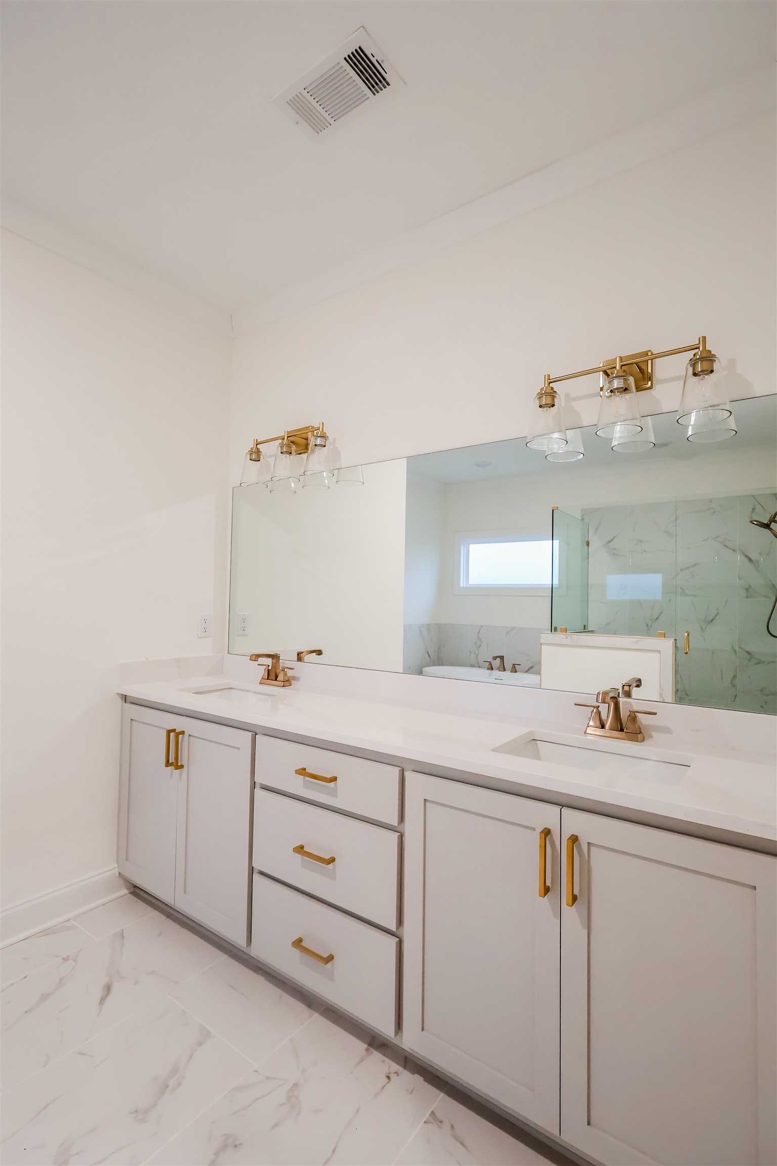 125 Columbia Way Atoka, TN 38004 - Photo 20 of 27 Full bathroom featuring double vanity, a marble finish shower, and light marble finish floors