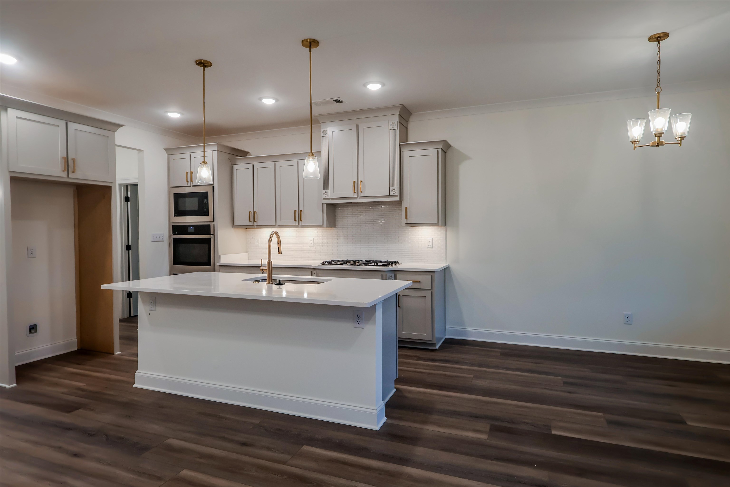 125 Columbia Way Atoka, TN 38004 - Photo 2 of 28 a kitchen with stainless steel appliances granite countertop a sink stove and refrigerator
