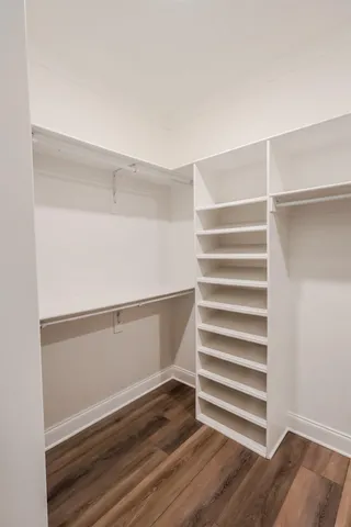 a view of walk in closet with empty racks