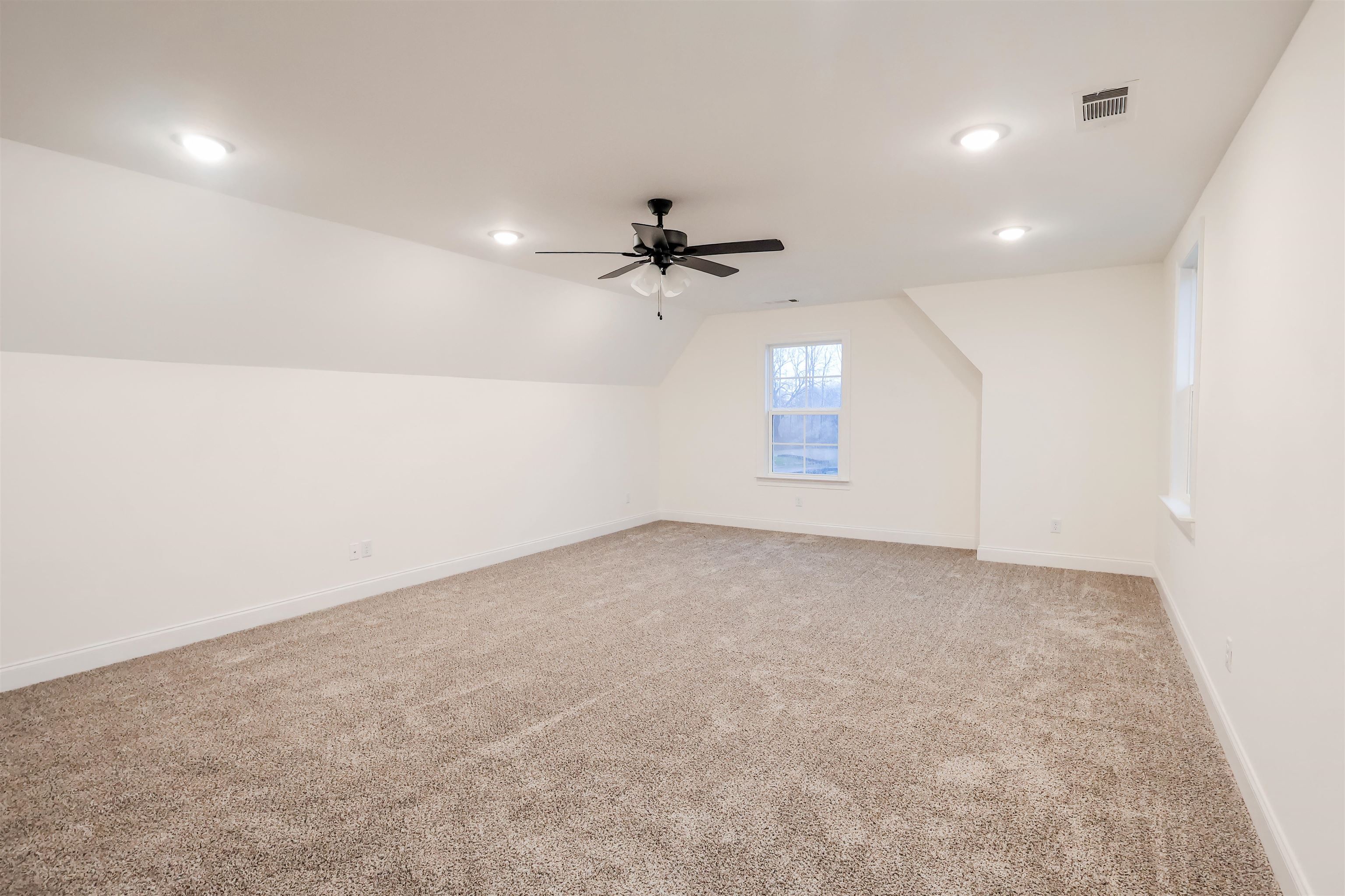 125 Columbia Way Atoka, TN 38004 - Photo 25 of 27 an empty room with a ceiling fan and window