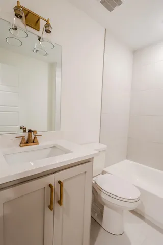 a bathroom with a sink a toilet and shower curtain