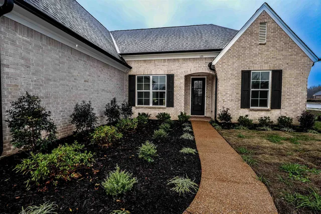a front view of a house with garden
