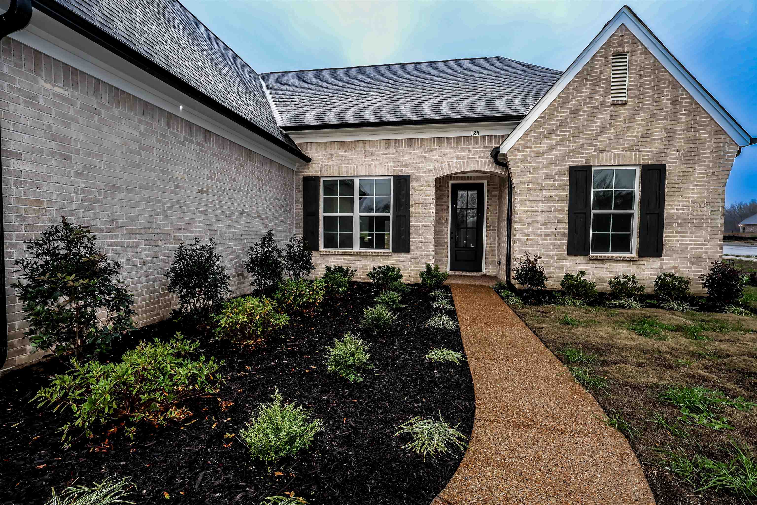 125 Columbia Way Atoka, TN 38004 - Photo 27 of 28 a front view of a house with garden
