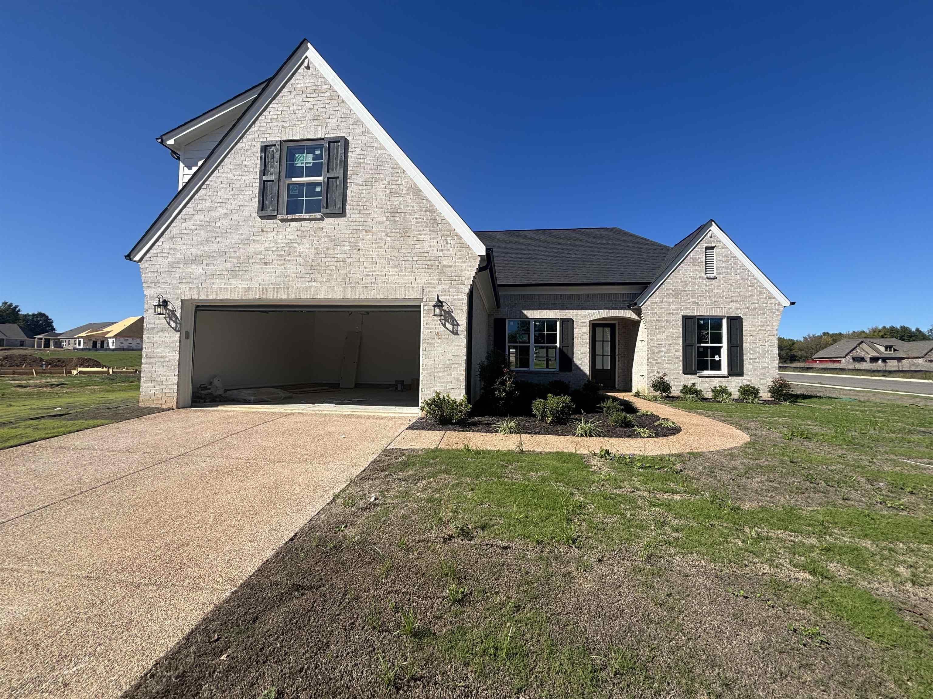 125 Columbia Way Atoka, TN 38004 - Photo 28 of 28 a front view of a house with yard and garage