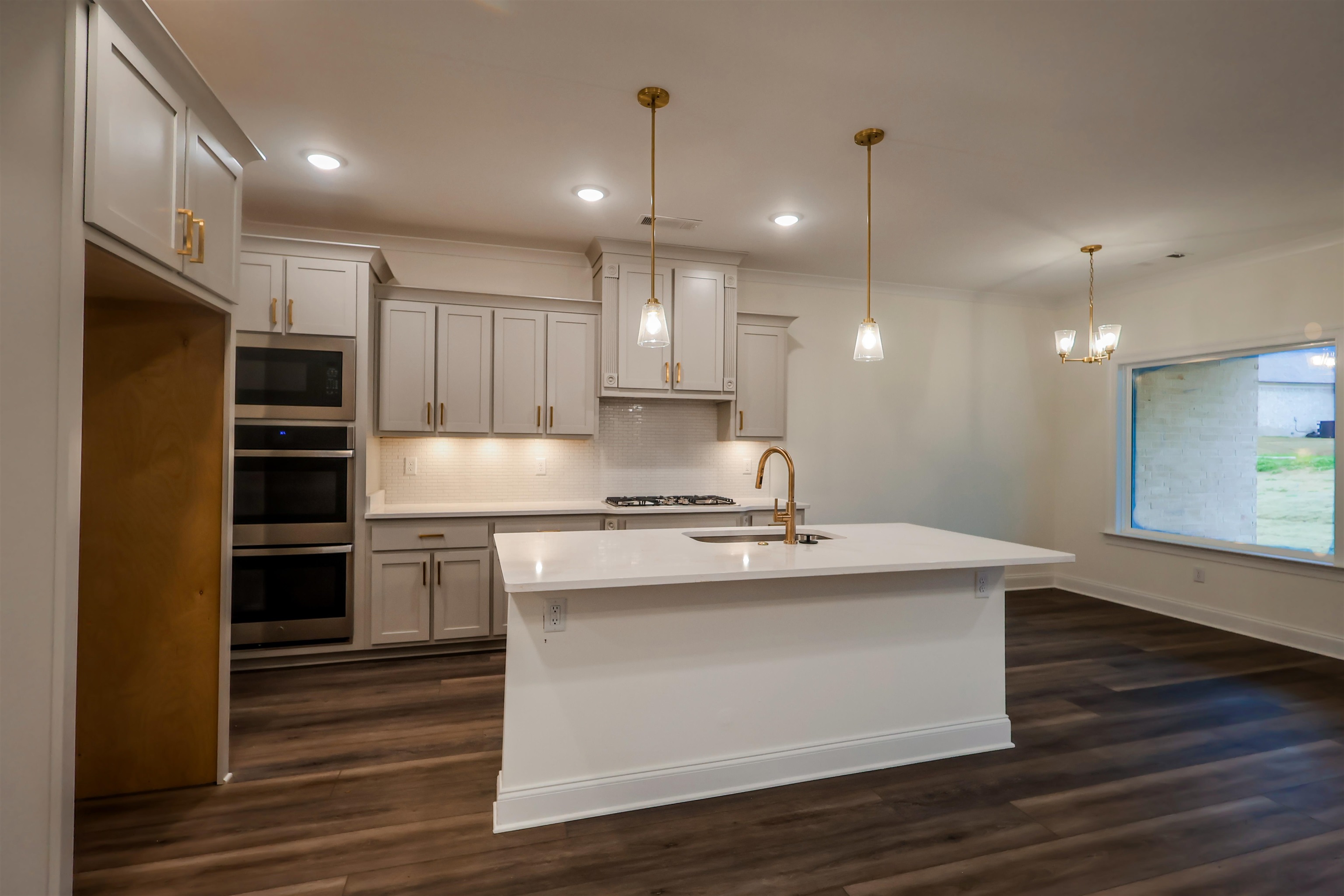 125 Columbia Way Atoka, TN 38004 - Photo 3 of 28 a kitchen with kitchen island a sink stainless steel appliances and cabinets