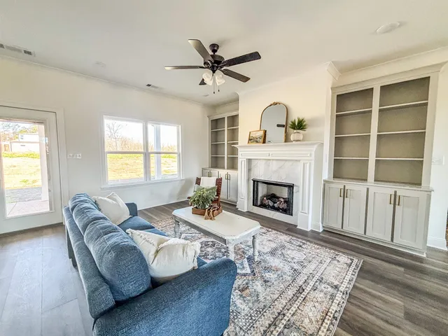 a living room with furniture and a fireplace