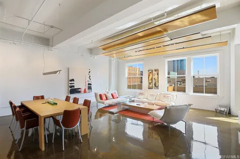 a living room with fireplace furniture and a table