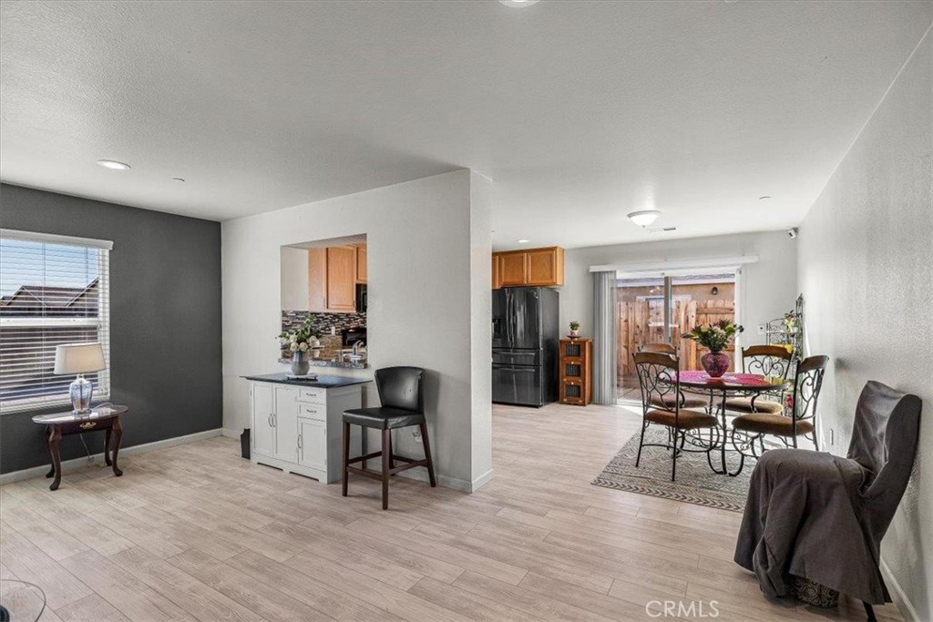 784 Taryn Court Merced, CA 95341 - Photo 13 of 39 a dining room with furniture and wooden floor