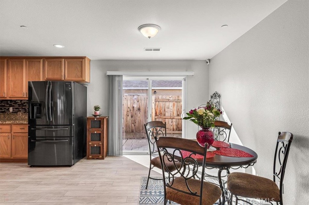 784 Taryn Court Merced, CA 95341 - Photo 14 of 39 a view of a dining room with furniture and wooden floor
