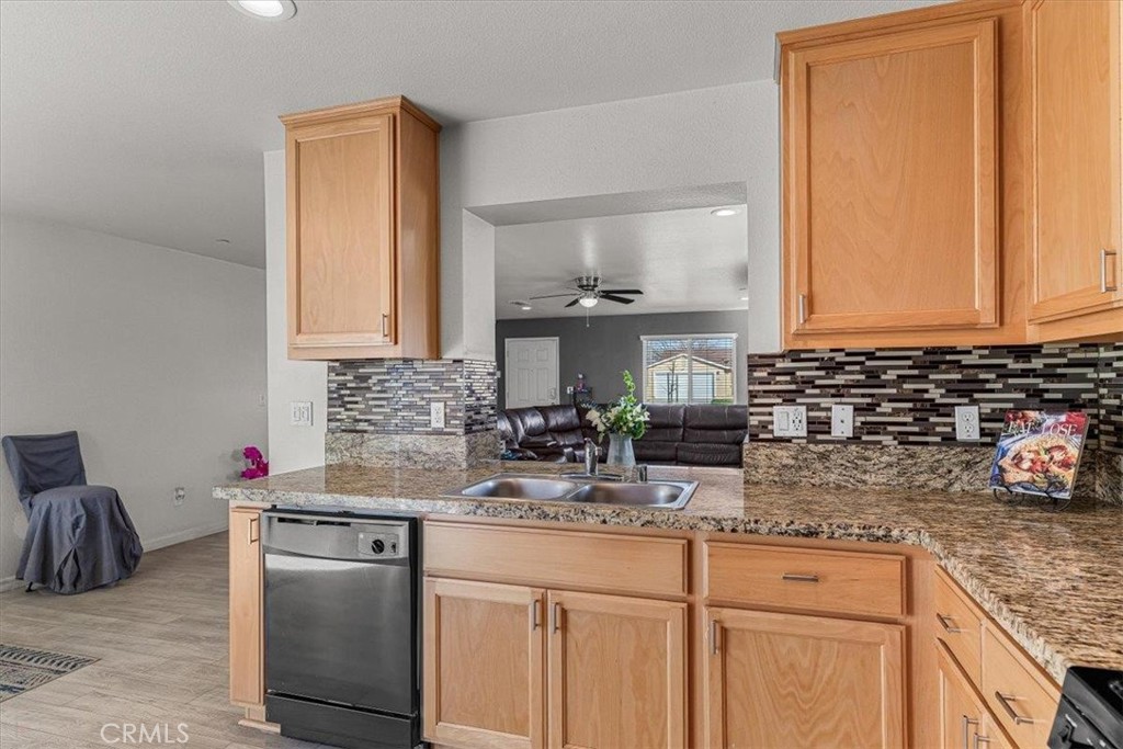 784 Taryn Court Merced, CA 95341 - Photo 18 of 39 a kitchen with stainless steel appliances granite countertop a sink stove and cabinets