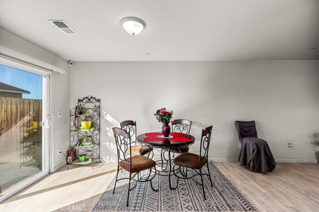 784 Taryn Court Merced, CA 95341 - Photo 20 of 39 a view of a dining room with furniture and wooden floor