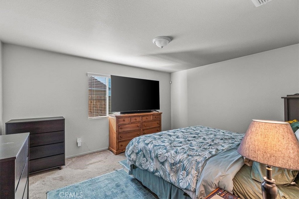 784 Taryn Court Merced, CA 95341 - Photo 22 of 39 a bedroom with a bed and a flat screen tv