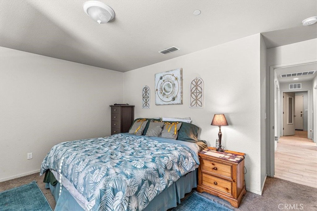 784 Taryn Court Merced, CA 95341 - Photo 23 of 39 a bedroom with a bed and painting on the wall