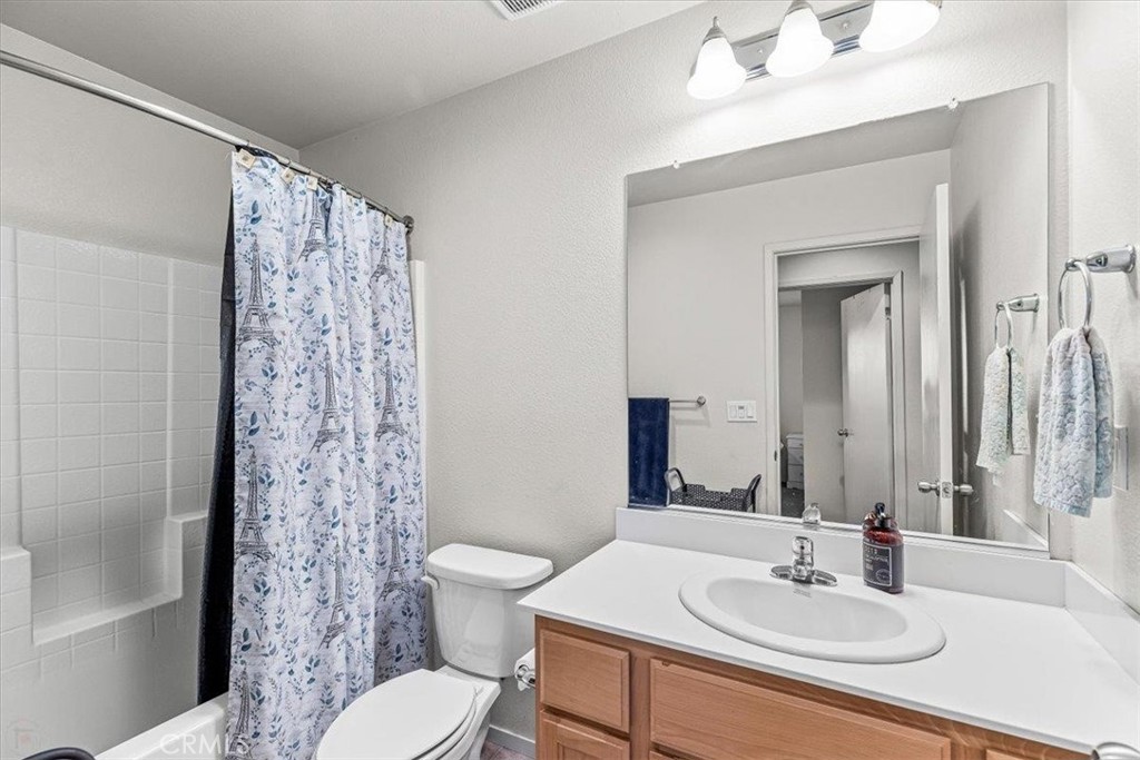 784 Taryn Court Merced, CA 95341 - Photo 28 of 39 a bathroom with a sink toilet a mirror and shower