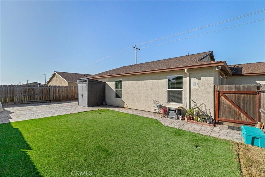 784 Taryn Court Merced, CA 95341 - Photo 35 of 39 a view of a backyard with a sitting area and wooden fence