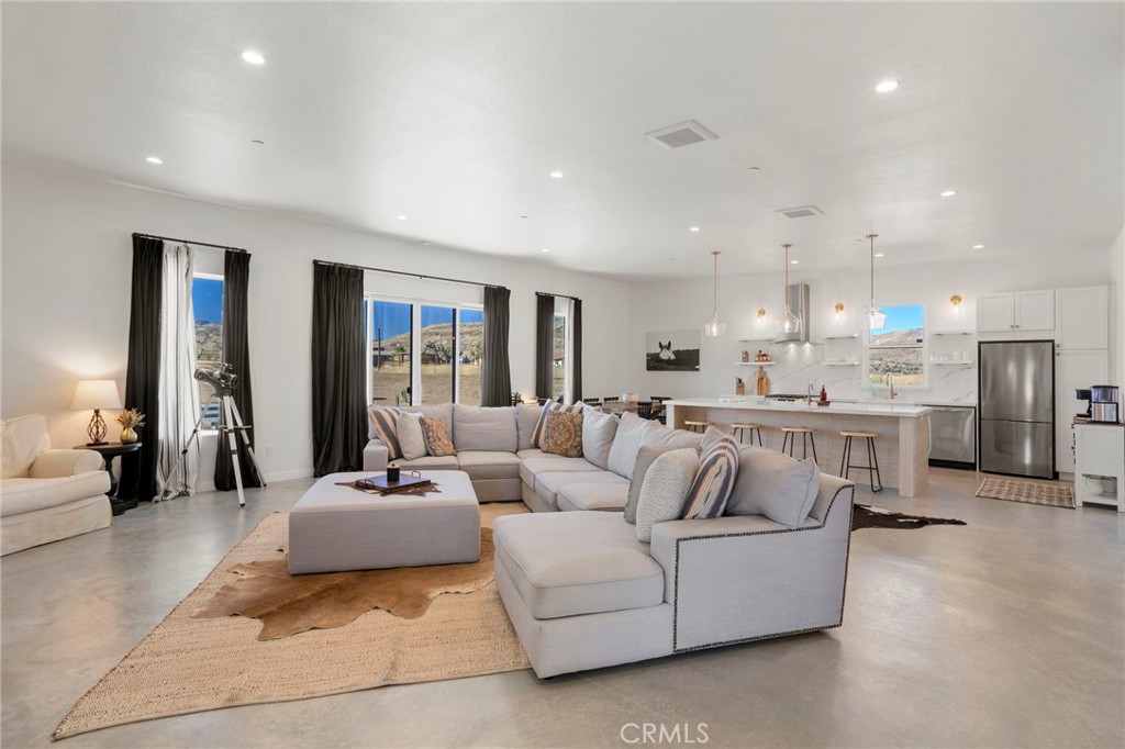 5145 Tom Mix Road Pioneertown, CA 92268 - Photo 11 of 75 a living room with furniture and a large window
