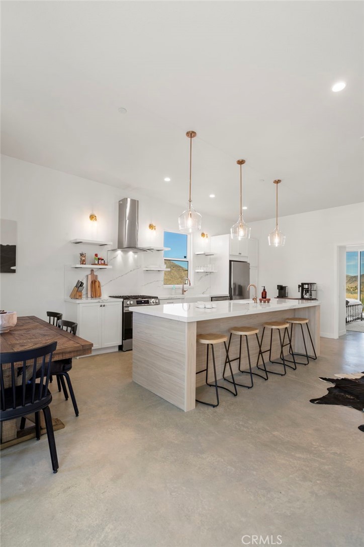 5145 Tom Mix Road Pioneertown, CA 92268 - Photo 28 of 75 a large kitchen with a table and chairs