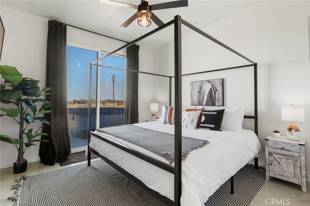 5145 Tom Mix Road Pioneertown, CA 92268 - Photo 35 of 75 a bedroom with a bed and a potted plant