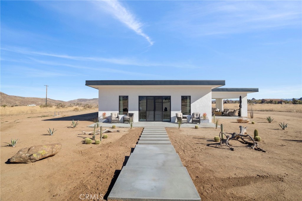 5145 Tom Mix Road Pioneertown, CA 92268 - Photo 5 of 75 a view of a swimming pool and lounge chair