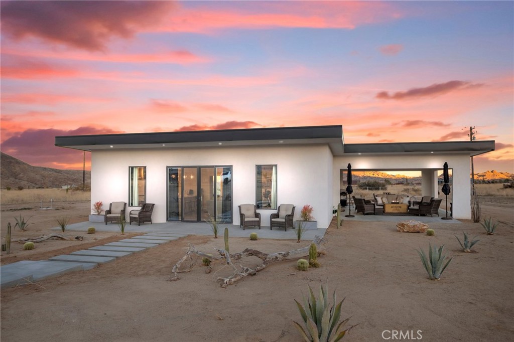 5145 Tom Mix Road Pioneertown, CA 92268 - Photo 64 of 75 a view of a house with outdoor space and sitting area