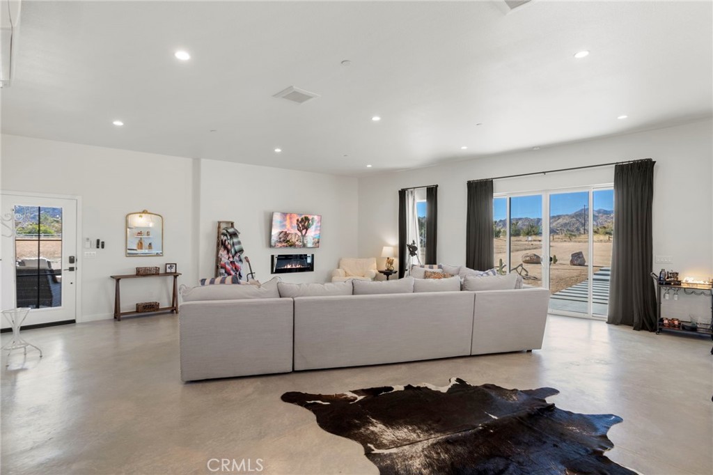 5145 Tom Mix Road Pioneertown, CA 92268 - Photo 10 of 75 a living room with furniture window and wooden floor