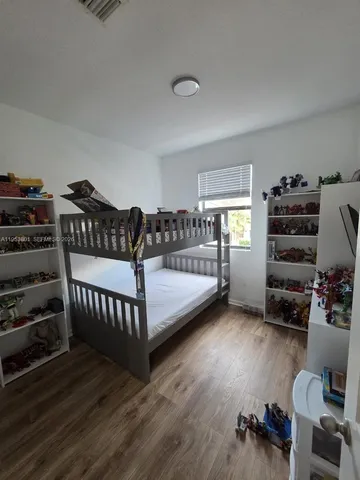 a bedroom with furniture and a wooden floor