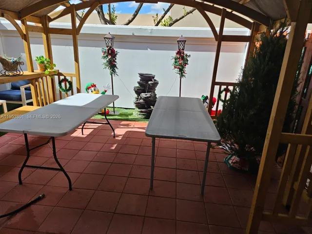 a view of a patio with table and chairs