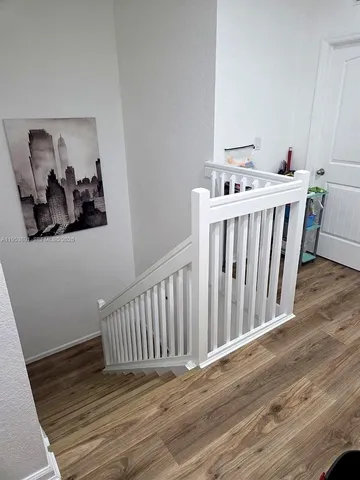 a view of a room with wooden floor