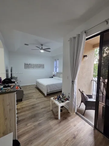 a bedroom with furniture and a wooden floor