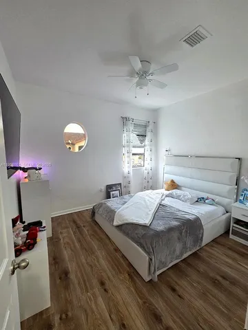 a bed room with a bed and a chandelier