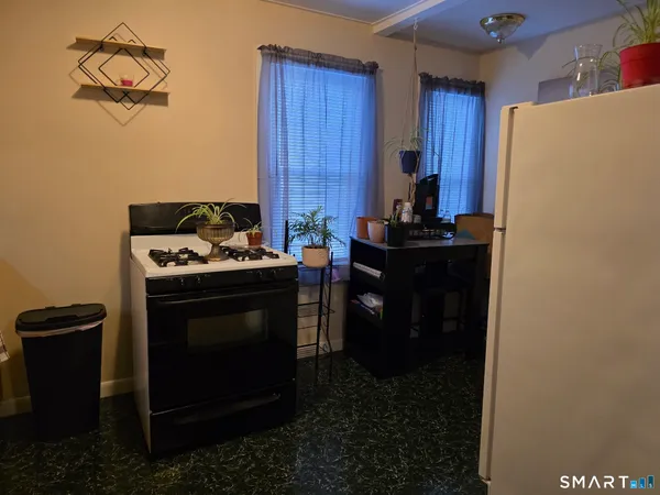 a kitchen with a stove and a refrigerator