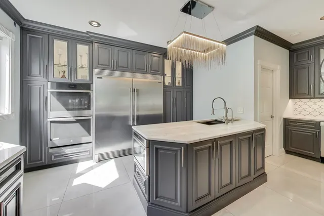 a kitchen with a refrigerator sink and stove