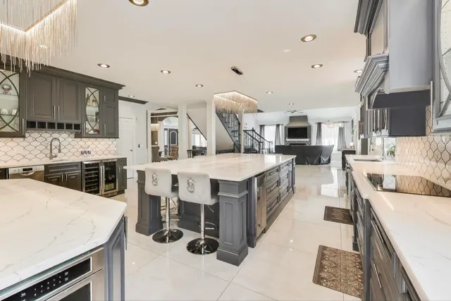 a kitchen with stainless steel appliances kitchen island granite countertop a sink and cabinets