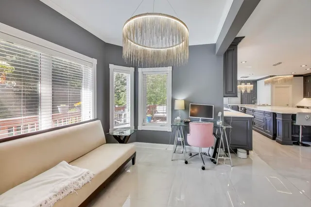 a bedroom with furniture and a large window