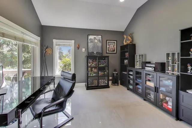 a living room with furniture a ceiling fan and a large window