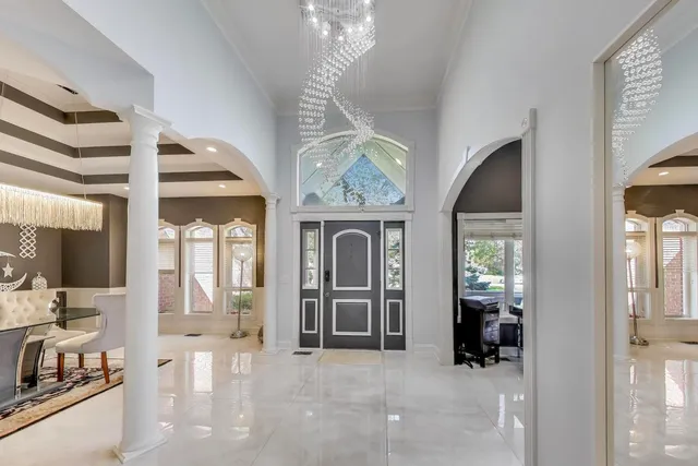 a view of a hallway with a livingroom with furniture