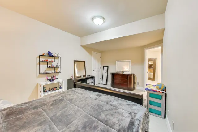 a bedroom with a bed and a dresser in it