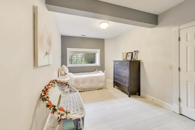 a bedroom with a bed and a chair