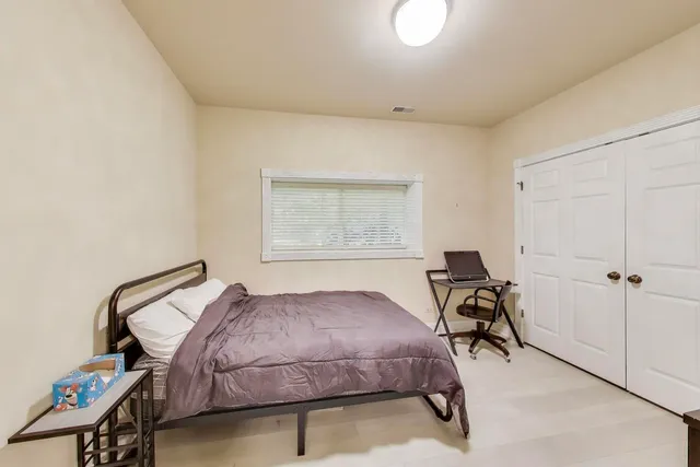 a bedroom with a bed and a cabinets