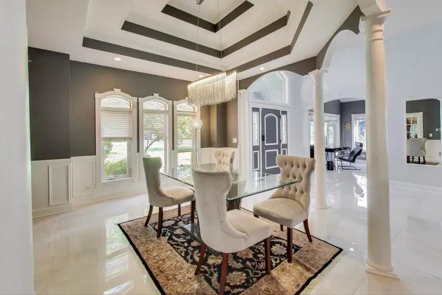 a view of a dining room with furniture wooden floor and a chandelier