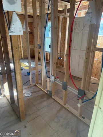 a view of an empty room with wooden floor and windows