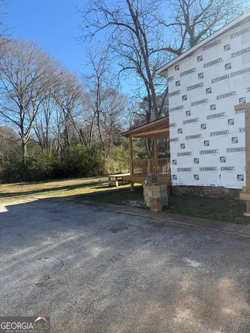 a view of backyard with large trees