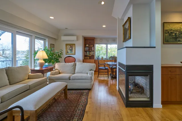 a living room with furniture wooden floor and a fireplace