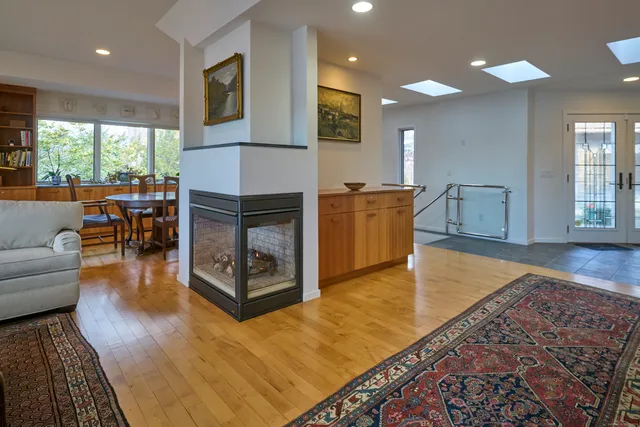 a living room with dining room and wooden floor