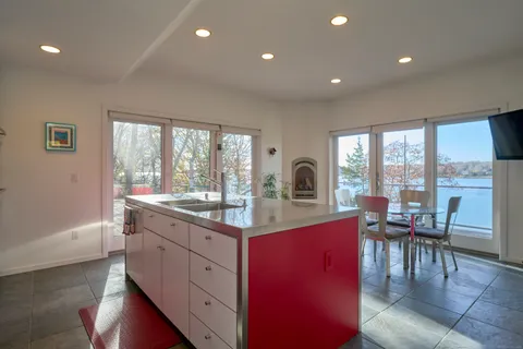 a kitchen with stainless steel appliances granite countertop a refrigerator and a stove top oven