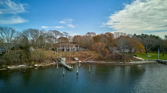 an aerial view of residential house with outdoor space and lake view
