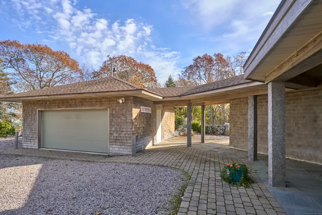 a living room with furniture floor to ceiling window and wooden floor