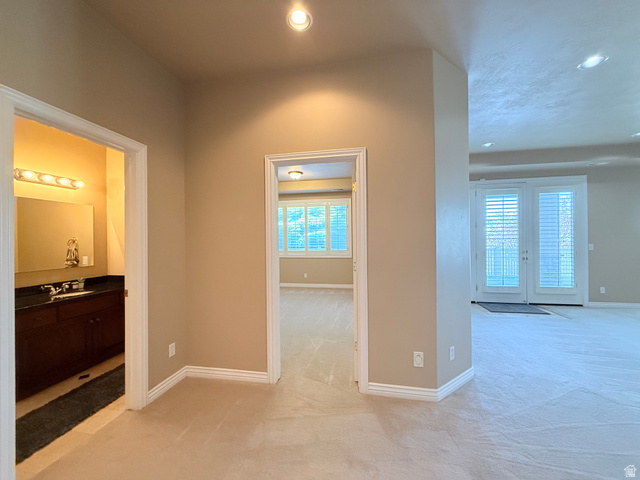 1562 Fairway Ridge Road Draper, UT 84020 - Photo 44 of 60 Plush carpeting throughout with recessed lighting, double doors with plantation shutters, and a full vanity with a dark countertop and ample storage